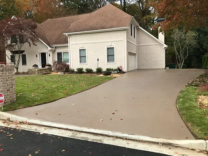 Resurfaced concrete driveway with warm custom color at a Kennesaw, Georgia home