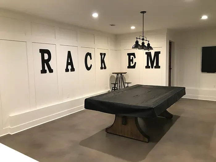 Charcoal stained concrete floor in a residential basement game room near Atlanta