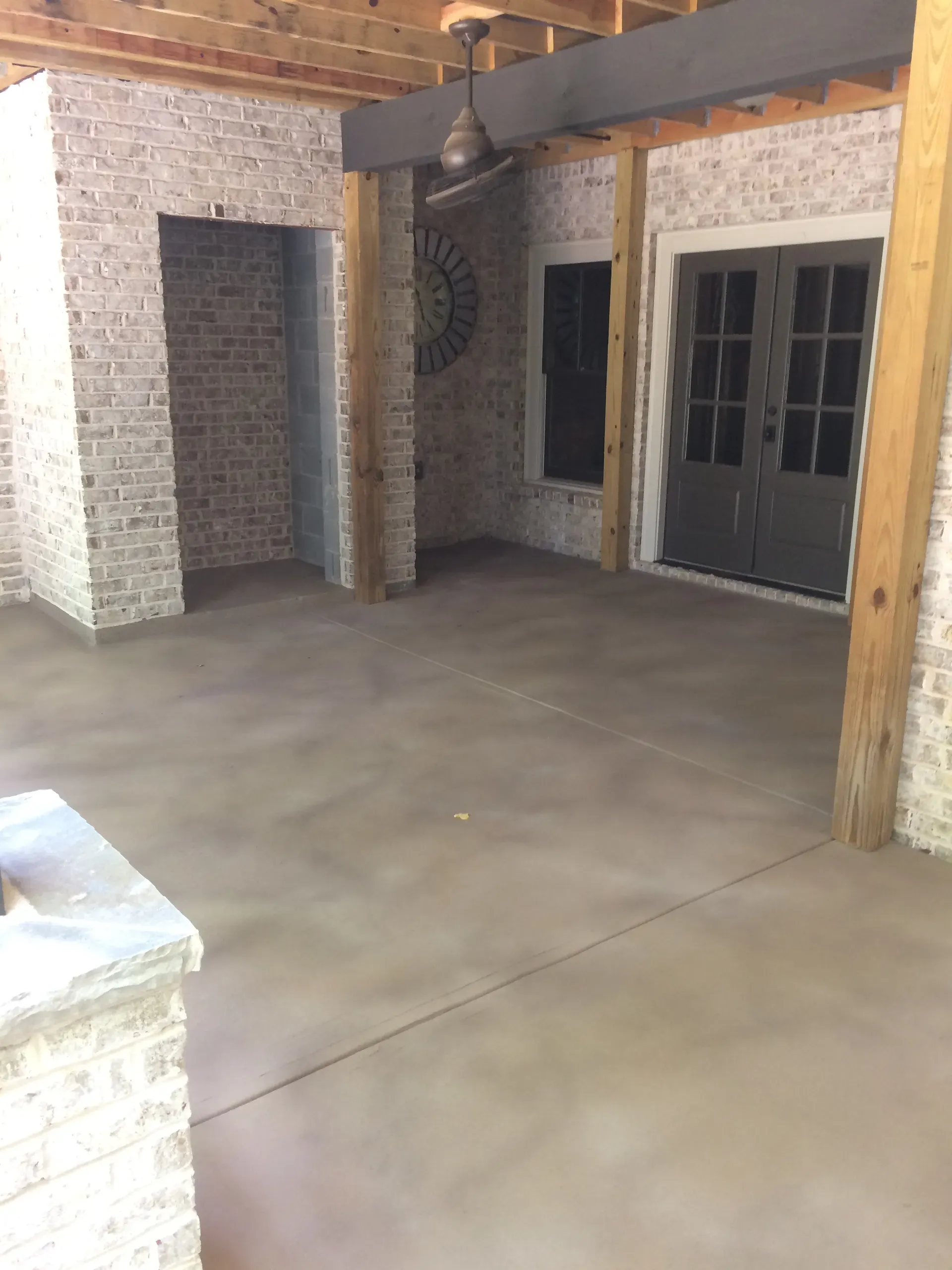 Covered outdoor patio with smooth decorative concrete finish near Atlanta