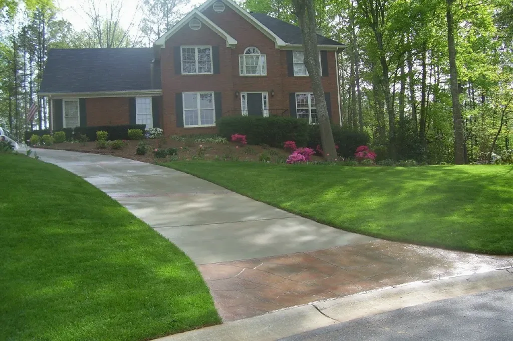 Concrete driveway with decorative stained apron adding curb appeal in the Atlanta area