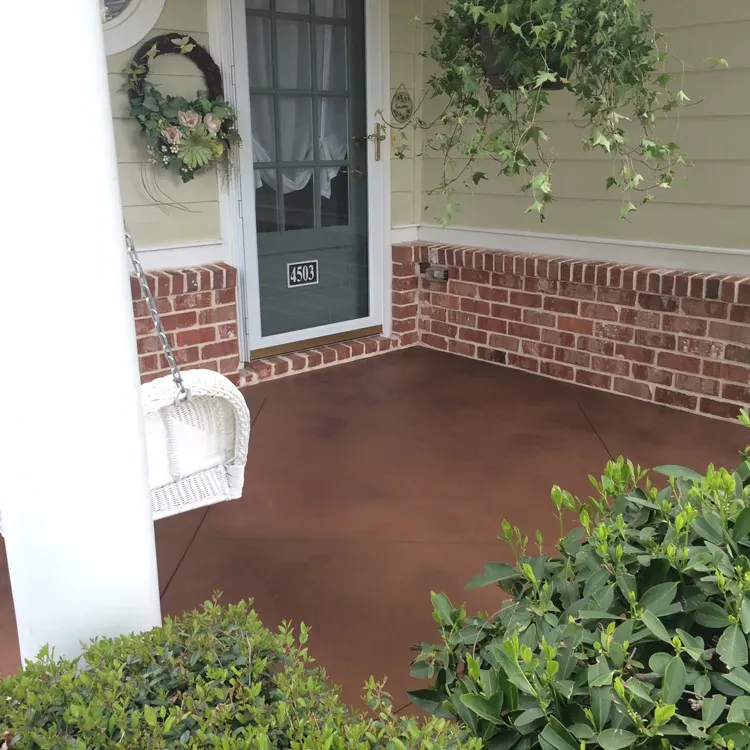 Front porch concrete stained a rich terracotta color by JP Concrete Creations