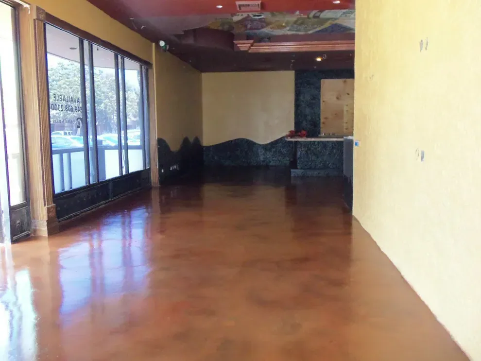 Rich red-brown stained and sealed interior concrete floor in a Georgia commercial space