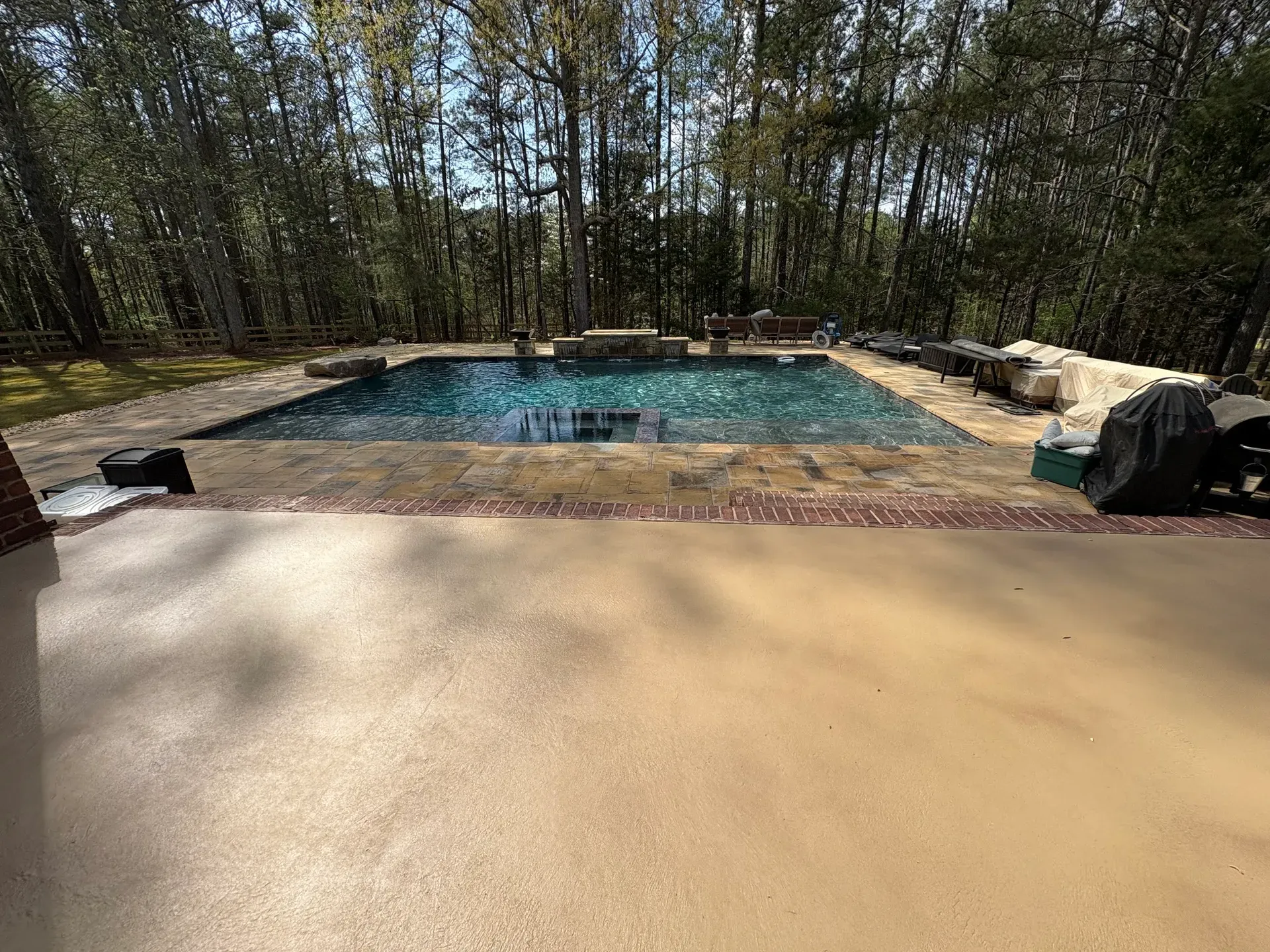 Large stained concrete pool deck and spa surround by JP Concrete Creations near Atlanta