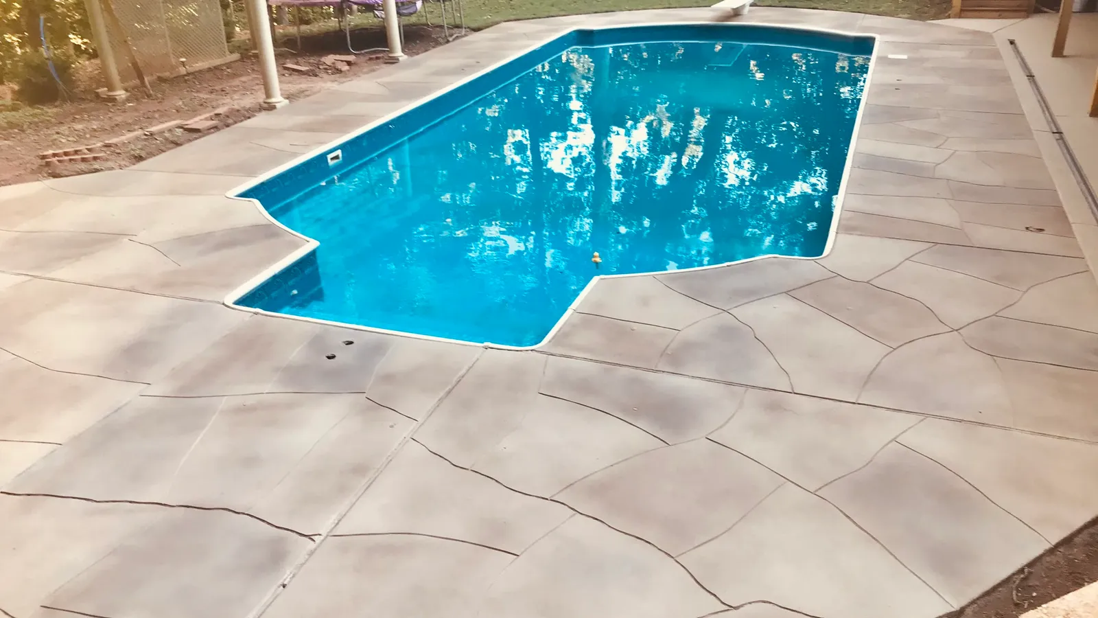 The same pool deck after a decorative flagstone-look concrete overlay