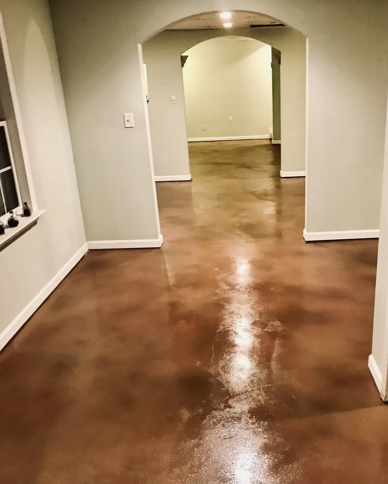 Rich red-brown acid stained and sealed concrete floor in a metro Atlanta home