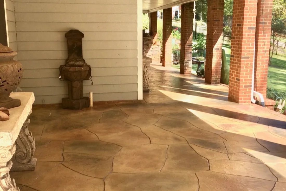 Covered patio finished with a flagstone-pattern concrete overlay in metro Atlanta