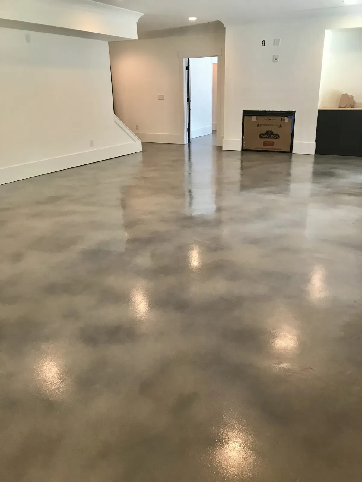 Glossy stained and sealed concrete basement floor in a Marietta GA home